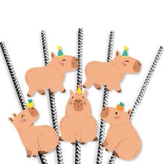 a group of brown animals standing next to each other on top of black and white striped sticks