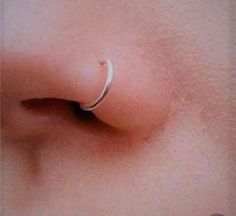 an image of a woman's nose with a ring on it that is attached to the side of her nose