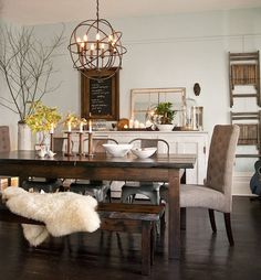 a dining room table with chairs and a bench