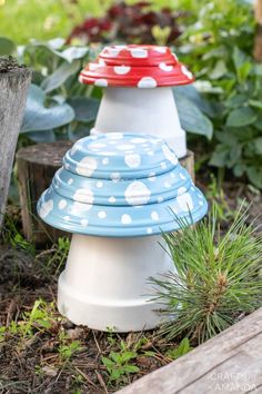 three plastic cups are stacked on top of each other in the garden