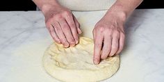 a person kneading dough on top of a counter