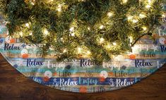 a christmas tree with lights on it is in the center of a round wooden table