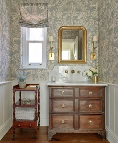 a bathroom with wallpaper and a wooden vanity