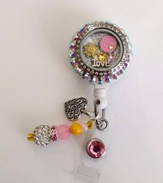 Charms can vary based on stock but will always be very similar and just as cute!!Floating locket with swarovski Crystal collection!   Swarovski crystals on this badge makes it one of a kind!This is a cute You R my sunshine floating locket badge reel. Comes as shown in picture!Badge reel..... This cute badge reel is handmade and comes with a very cute charm and dangling beads as shown in the pic. Show off your new handmade badge reel to all your co-workers!!!All badge reels come on a slide clip!A Themed Customizable Badge Reel As Gift, Adjustable Multicolor Badge Reel For Gift, Cheap Personalized Themed Badge Reel, Adjustable Badge Reel With Key Clip Gift, Nurse Crafts, Handmade Novelty Badge Reel For Personal Use, Badge Reels Diy, Cute Badge Reel, Floating Lockets