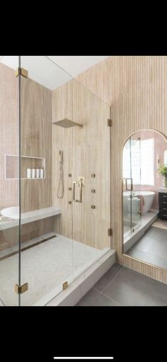 a bathroom with a walk in shower next to a bathtub and sink under a mirror