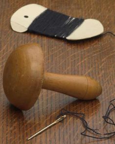 a wooden mallet sitting on top of a table next to a pair of scissors