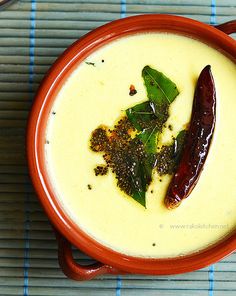 a red bowl filled with soup on top of a table