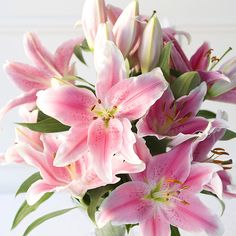 a vase filled with pink flowers on top of a table