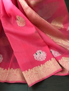 This is a beautiful handloom pure kora silk banarasi saree in a pleasant shade of bubblegum pink with kadwa sona rupa meenakari bird motifs in body, kadwa gold zari borders and sona rupa kadwa motifs in pallu. Saree comes with an unstitched blouse piece with motifs woven in kadwa technique. Falls, pico and tassels are done. Colour may vary slightly depending upon lighting. Handloom products may have some irregularities. All sales are final. Dry clean only. Pink Tissue Silk Traditional Wear With Pallu, Pink Tissue Silk Saree For Festivals, Pink Tissue Silk Dupatta With Pallu Detail, Pink Tissue Silk Dupatta With Pallu, Pink Tissue Silk Saree With Self Design, Pink Zari Weaved Tissue Silk Dupatta, Traditional Pink Tissue Silk Dupatta, Pink Handloom Tissue Silk Saree, Pink Tissue Silk Saree With Zari Weaving