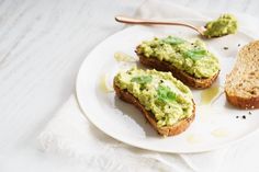 two pieces of bread with guacamole on them