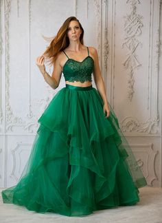 The Noel Skirt is a stunning tulle skirt ready for a twirl worth experience.. Shown in emerald green tulle, polyester satin lining and zipper for the perfect twirl worthy skirt. This skirt is made to order please allow 4-6 week for shipping. matching top sold separately. Need a shorter length? Longer? Choose Custom at checkout and this skirt can be made to your exact measurements. Custom colors are available as well. Elegant Green Tulle Skirt, Green Long Tulle Skirt, Green Full Ruffled Skirt, Green Full Skirt For Wedding, Green Long Dress With Ruffled Skirt, Green Ruffled Full Skirt, Flowy Organza Skirt For Prom, Green Tulle Skirt For Party, Green Tiered Tulle Skirt