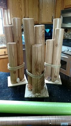 several pieces of wood are tied together on the kitchen counter top with green chopsticks next to them