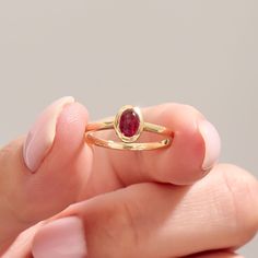 The 14k Solid Gold Red Gemstone Ring is stunning handmade jewelry, perfect for engagements or special occasions. Featuring a vibrant red tourmaline, this bezel-set birthstone solitaire ring is designed for women who appreciate unique and elegant jewelry. Crafted in 14k solid gold, it's a timeless accessory that adds a touch of sophistication to any outfit. Ring Details   ❥ Gold KT: 14k Solid Gold (also in 10, 18K)  ❥ Gold Color Options: White, Yellow, Rose Gold  ❥ Top Width: 8.00x6.20 mm  ❥ Top Heirloom Garnet Ring With Bezel Setting, Formal Ruby Stackable Rings, Ruby Birthstone Ring With Round Band, Red Ruby Ring With Bezel Setting, Classic Oval Ruby Ring Stackable, Gold Ruby Birthstone Ring With Bezel Setting, Oval Ruby Stackable Ring For Anniversary, Heirloom Ruby Jewelry With Bezel Setting, Oval Stackable Ruby Ring For Anniversary