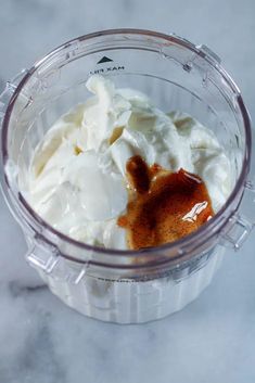 a blender filled with whipped cream and sauce