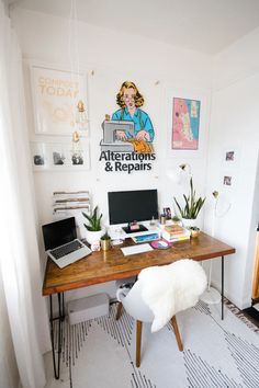 a desk with a laptop computer sitting on top of it next to a white rug