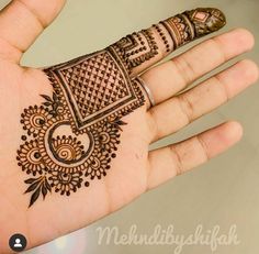 the hand is decorated with henna designs on it