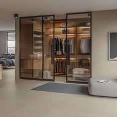 an open closet with clothes on hangers and a rug in front of the sliding glass doors