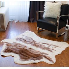 a living room with a chair and rug on the floor