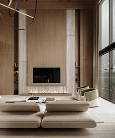 a living room with two couches and a fireplace in the center, surrounded by wooden paneling