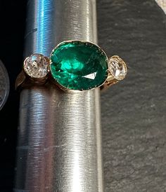 "Antique 14K classic Diamond and I believe Emerald man made paste ring.  Size 4 3/4, wt.- 2.6 grams, top of ring approx. 1/3\" by 2/3\".  Condition is very good for it's age any slight wear commensurate with age-photos show the details.. Super entering gold setting with wonderful rich Emerald green color stone flanked by two old world cut white Diamonds(approx. 45 pt total wt for two Diamonds), lots of intriguing look to this beauty.  Tests for 14k.  Unique timeless design." Age Photos, Emerald Green Color, Vintage Keys, Color Stone, Yellow Gold Ring, Gold Diamond Rings, Gold Set, White Diamonds, Yellow Gold Rings