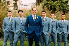 a group of men in suits standing next to each other