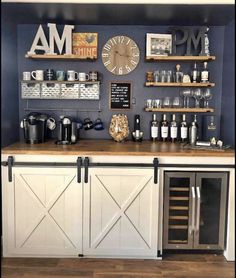 a bar with lots of bottles and glasses on top of it, next to a clock