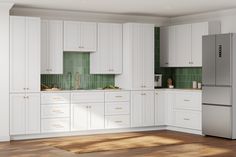 a kitchen with white cabinets and green tile backsplash, wood flooring and a stainless steel refrigerator