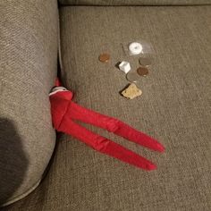 an elf is sitting on the couch next to some coins