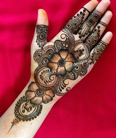 a woman's hand is decorated with hennap and intricate designs on it