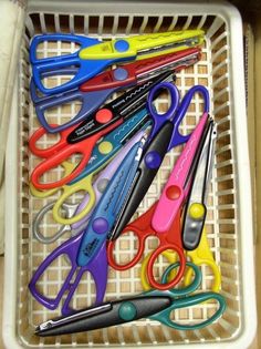 a basket filled with lots of different colored scissors