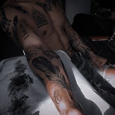 a man with many tattoos on his arm