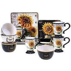 a set of coffee cups and saucers with sunflowers painted on the side