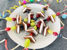 several pieces of cake on a plate surrounded by streamers