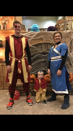 a man and woman in costumes standing next to a child dressed as peter panton