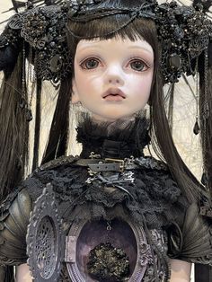 a doll is dressed in black and has feathers on her head, while she holds a clock