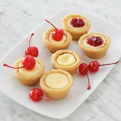 small desserts with cherries on a white plate