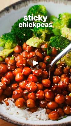 a bowl filled with broccoli and chickpeas on top of white rice