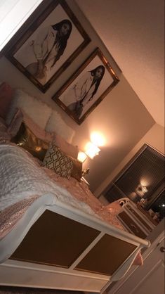 a bedroom with pictures on the wall above it