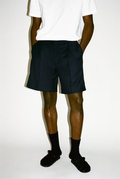 A Southern California summer staple elevated with effortless tailoring. The villa shorts combine a lightweight 100% wool exterior with a relaxed, pleated wide-leg opening. The result is a beautifully draped pair of shorts that can to take you from all day at the Getty Villa to your oceanside Nobu reso. Mens Pleated Shorts, Summer Shorts With Welt Pockets, Chic Pleated Shorts For Workwear In Summer, Summer Workwear Pleated Shorts, Relaxed Fit Pleated Shorts, Relaxed Fit Pleated Short Bottoms, Pleated Relaxed Fit Short Bottoms, Pleated Relaxed Fit Shorts, Relaxed Pleated Shorts