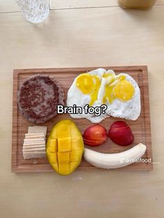 a wooden tray topped with food on top of a table