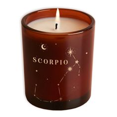 a candle with the word scorpio on it and stars in the sky