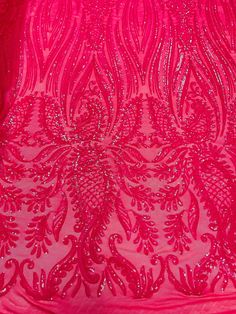 the back of a pink dress with sequins on it and an intricate design