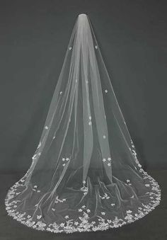 a wedding veil with white flowers on it