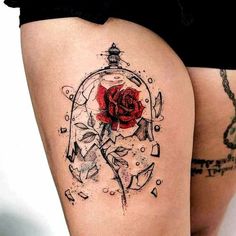 a woman's thigh with a rose tattoo on it