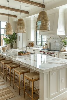 a large kitchen with white cabinets and marble counter tops, along with bar stools