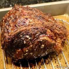 a large piece of meat sitting on top of a grill