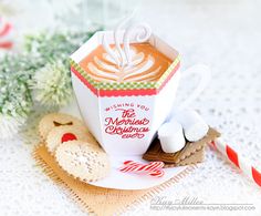 a cup of hot chocolate and marshmallows on a plate with candy canes