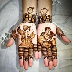 two hands with hendi designs on them