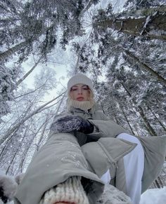 a woman sitting in the snow with her feet up