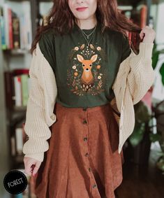 Fawn & Fairy Tales 🦌🍁  Fall into Fawn Magic and welcome the colors of fall with our Cute Fawn Boho Style T-Shirt. A seamless blend of cottagecore serenity and forestcore mystery, this tee is an ode to autumn's charm. Adorned with woodland aesthetic details and wildlife designs, it's a perfect gift for nature lovers and a timeless addition to your Fall wardrobe.   Here's what you need to know  High-quality and durable print through Direct-To-Garment (DGT) printing ★ Fit ★ This is a unisex T-shirt. It might be a bit larger than your usual size. So, check out our size chart to find your perfect fit. Want an oversized look? Pick a size larger than you normally would. For a snug fit, go a size down.👕🔍 ★ Fabric ★ We're all about comfort and quality. ● It's lightweight and thin - perfect for Fox Shirt, Cottagecore Shirt, Estilo Indie, Cottagecore Outfits, Estilo Hippie, Mode Boho, Granola Girl, Mode Inspo, Aesthetic Outfits